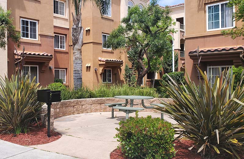 Exterior view of building with seating and BBQ area